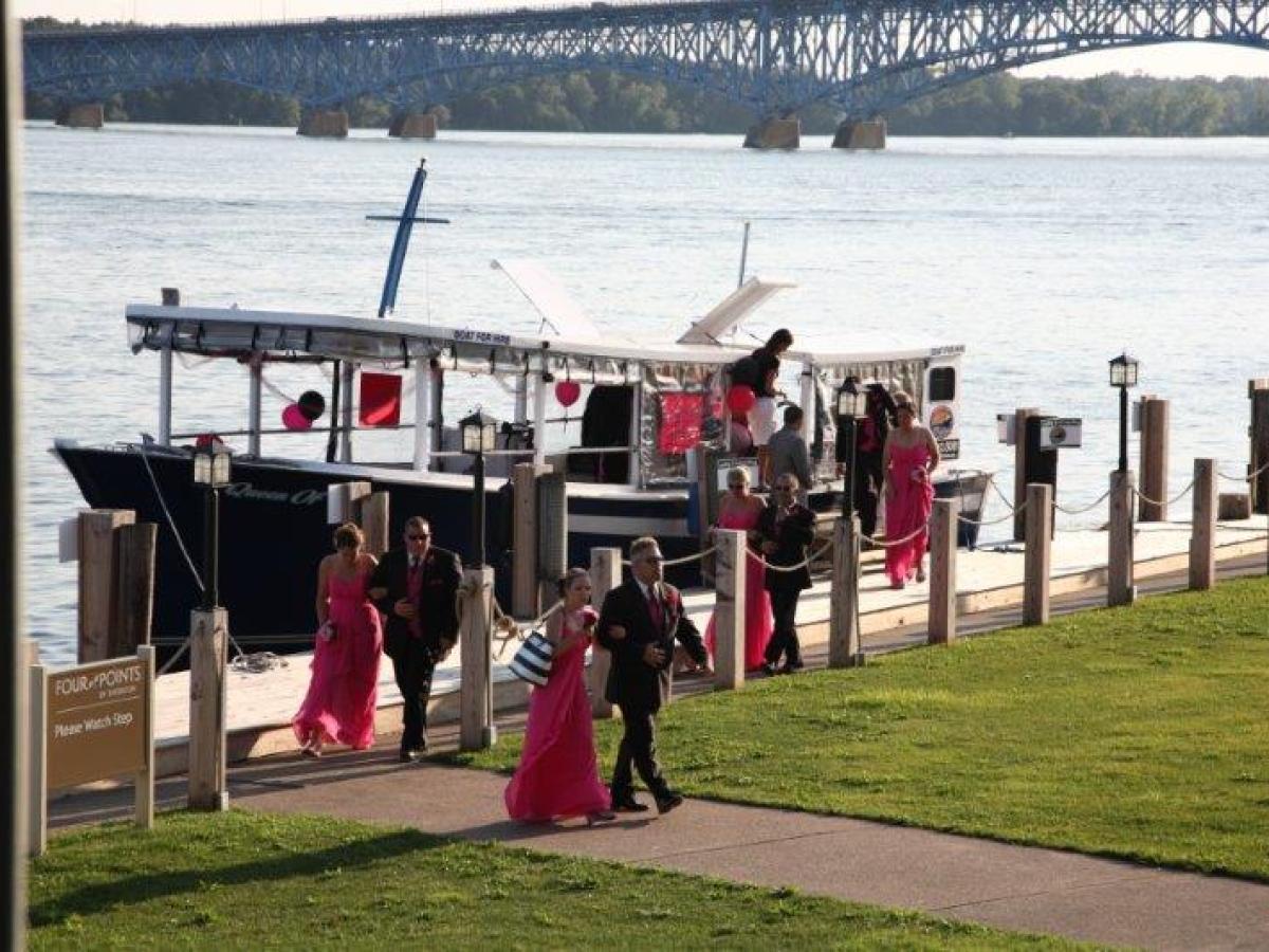 a group of people standing in front of a body of water