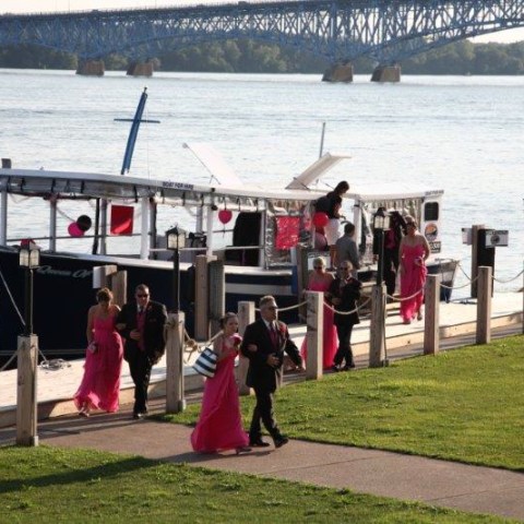 a group of people standing in front of a body of water