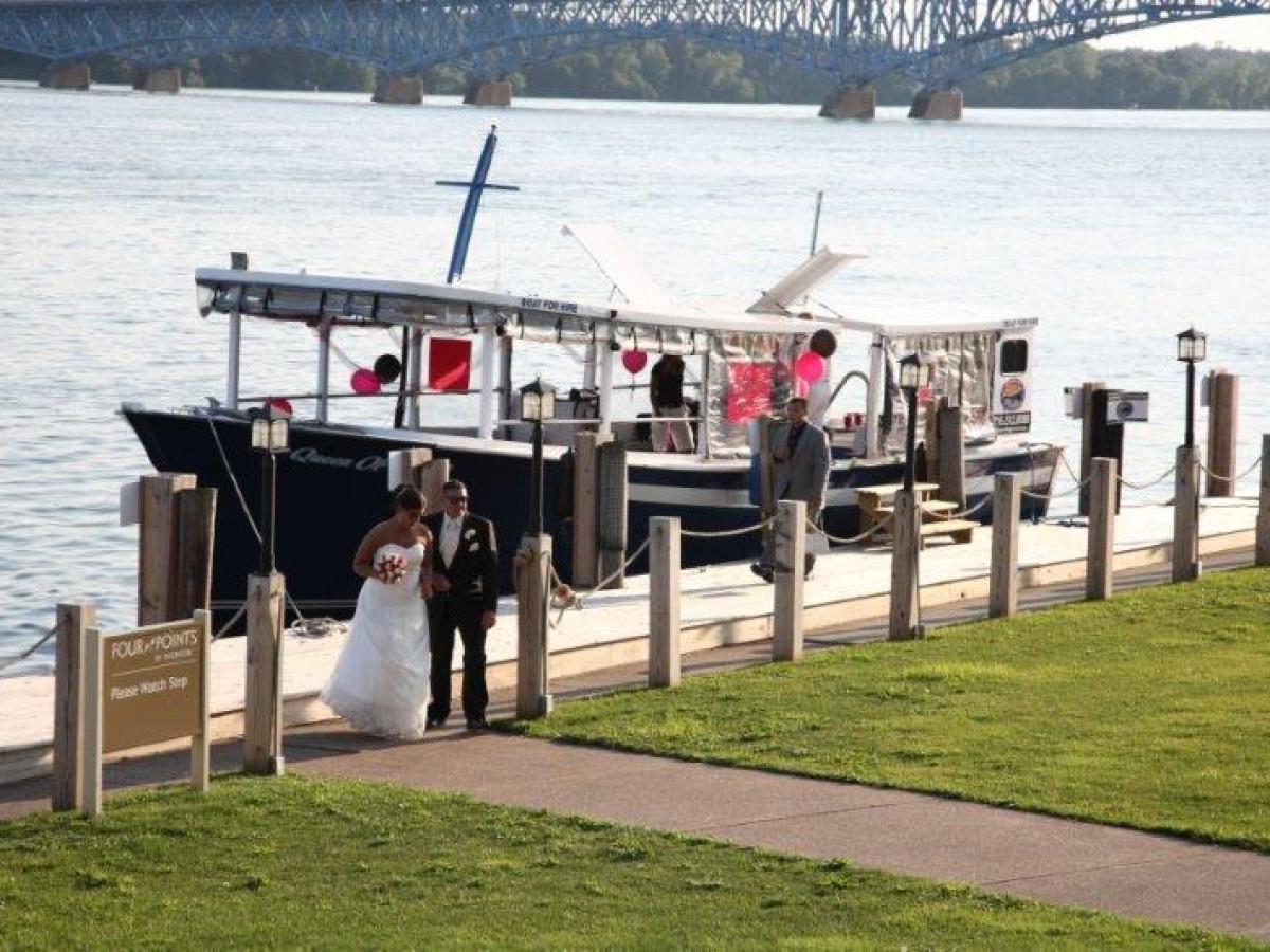 a group of people standing in front of a body of water