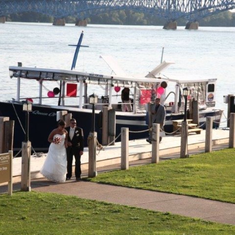 a group of people standing in front of a body of water
