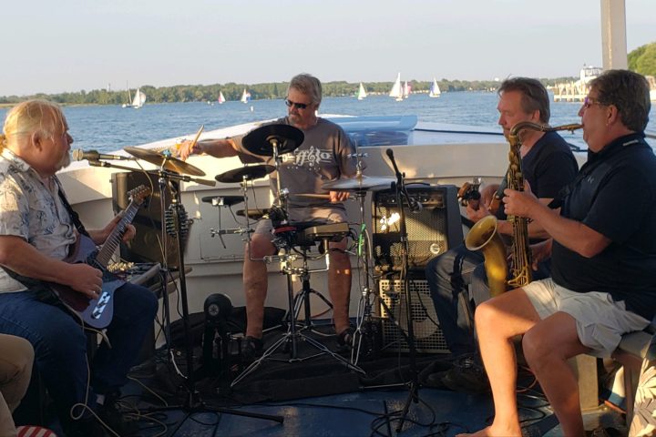 a group of people sitting on a boat in the water