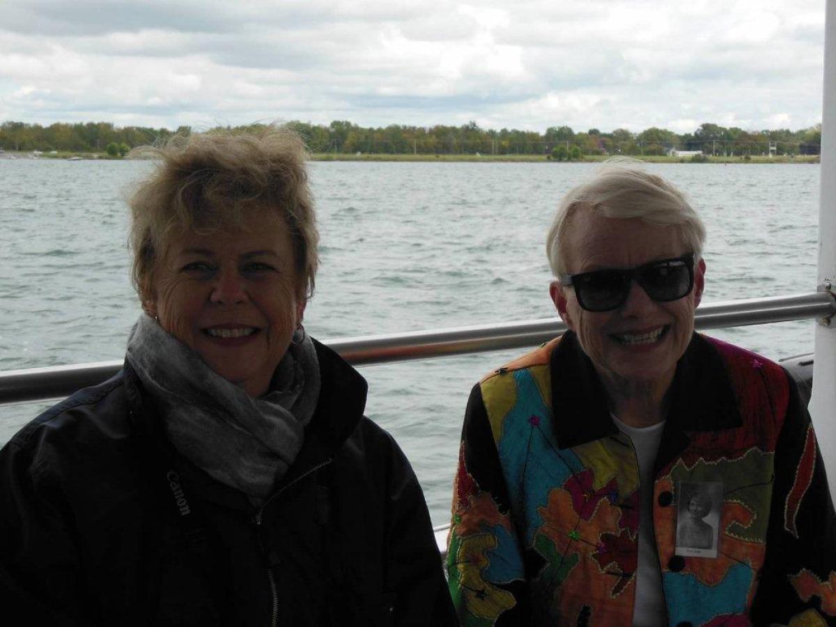 a group of people standing next to a body of water