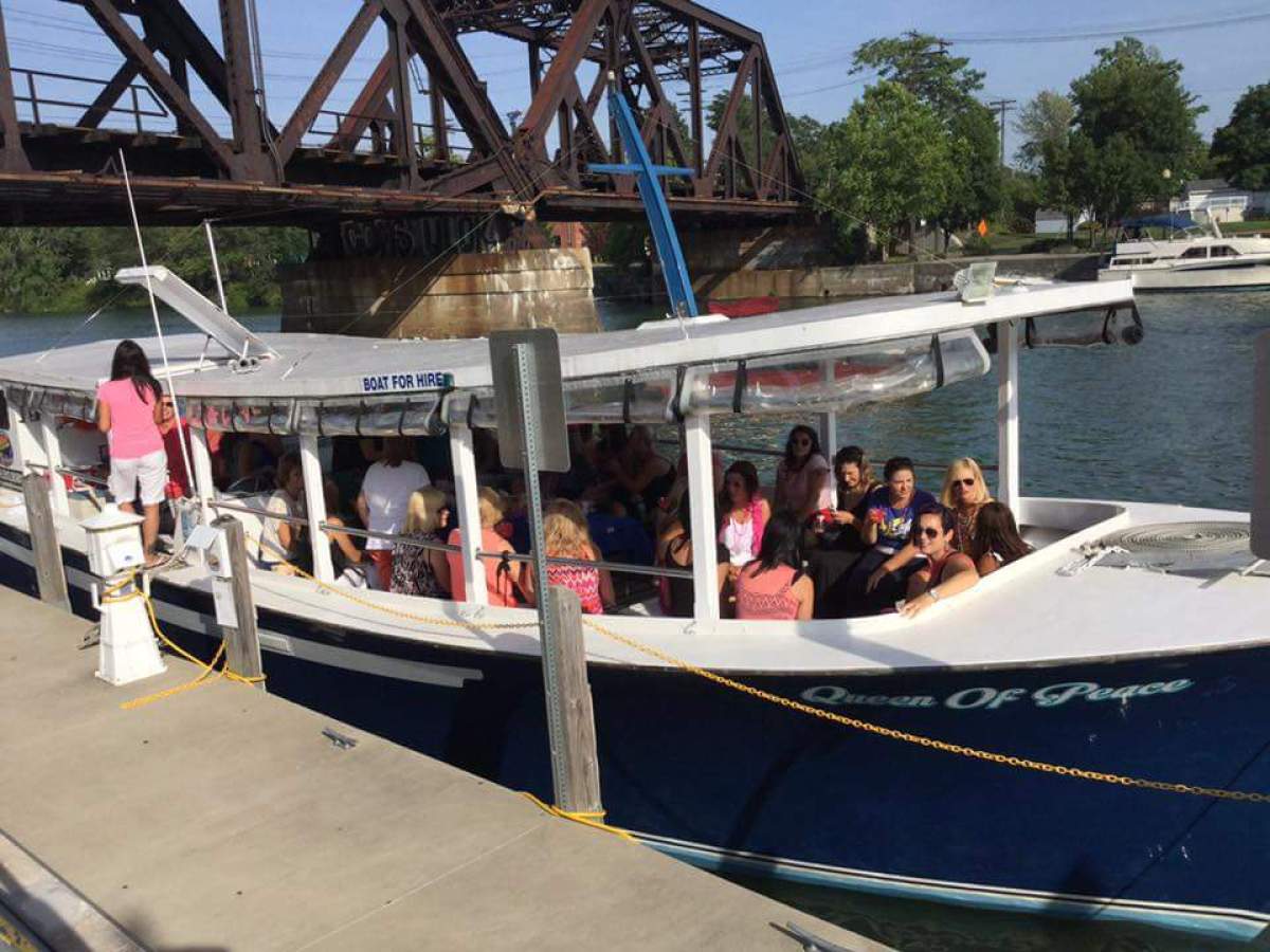 a group of people in a boat docked at a dock