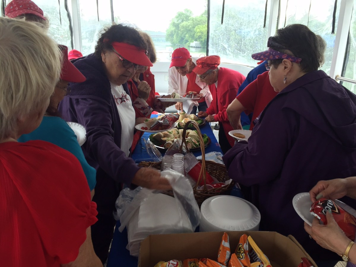 a group of people sitting at a table eating food