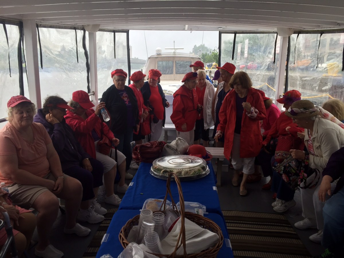 a group of people standing next to a window