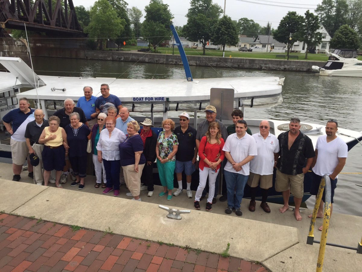 a group of people standing on a sidewalk
