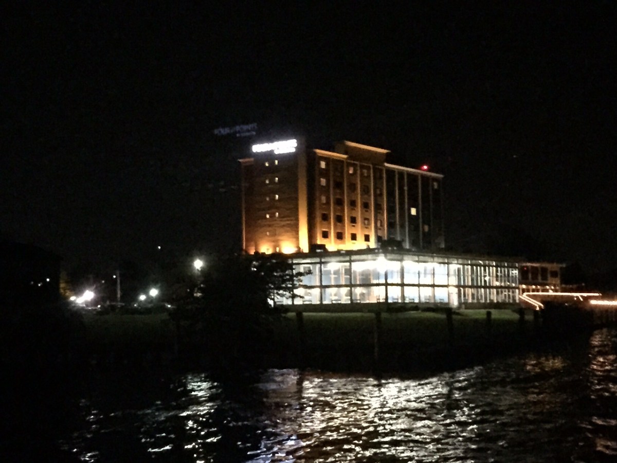 a large body of water with a city in the night sky