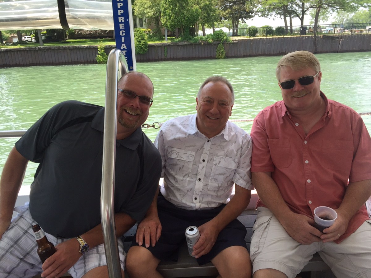 a group of people sitting at a dock