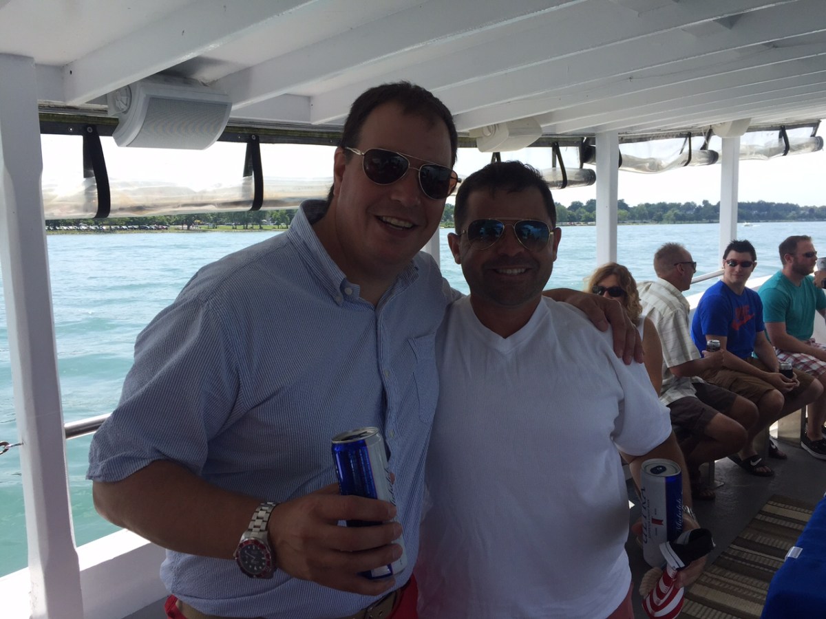 a group of people standing on a boat in the water