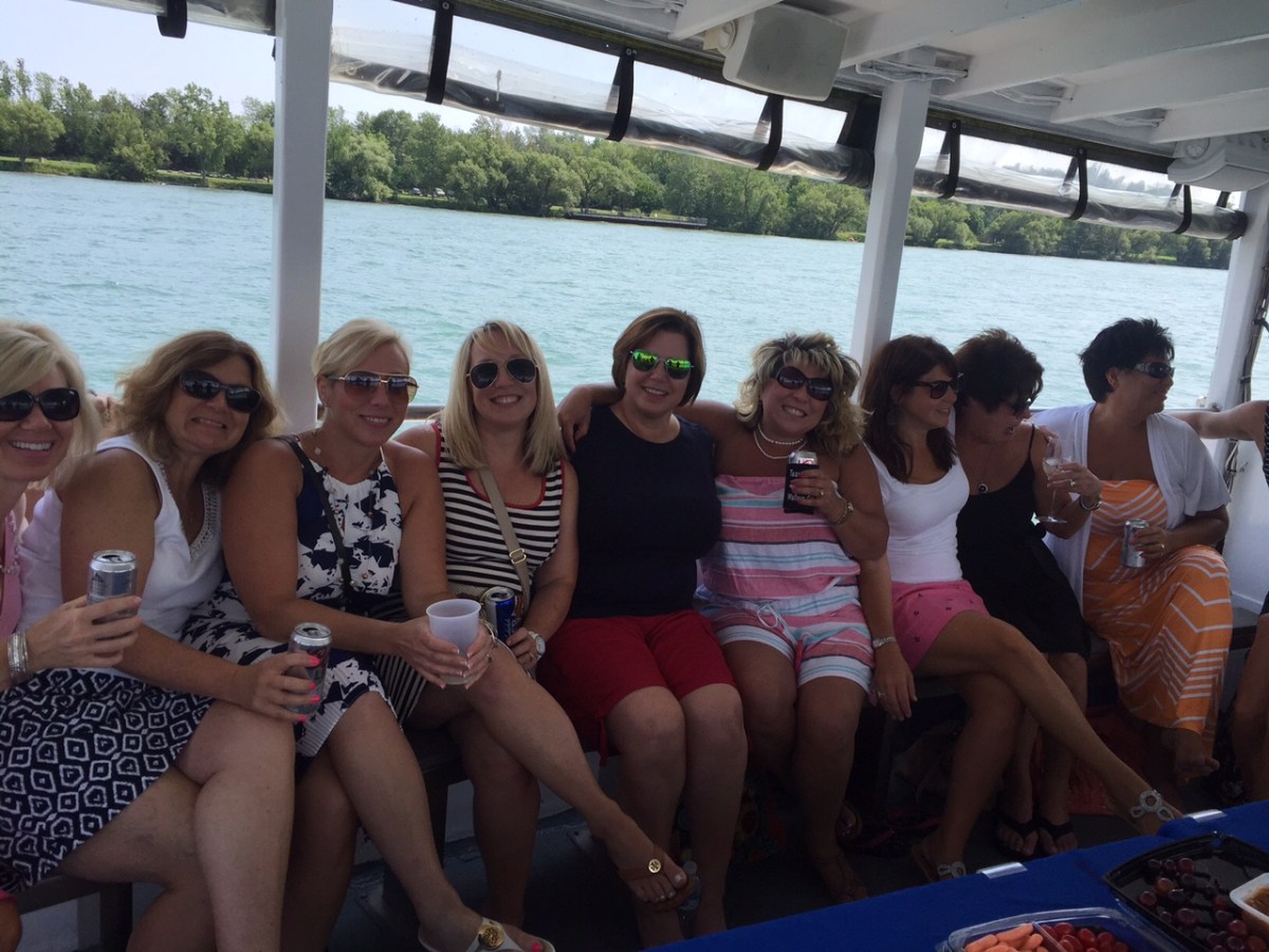 a group of people sitting in front of a body of water