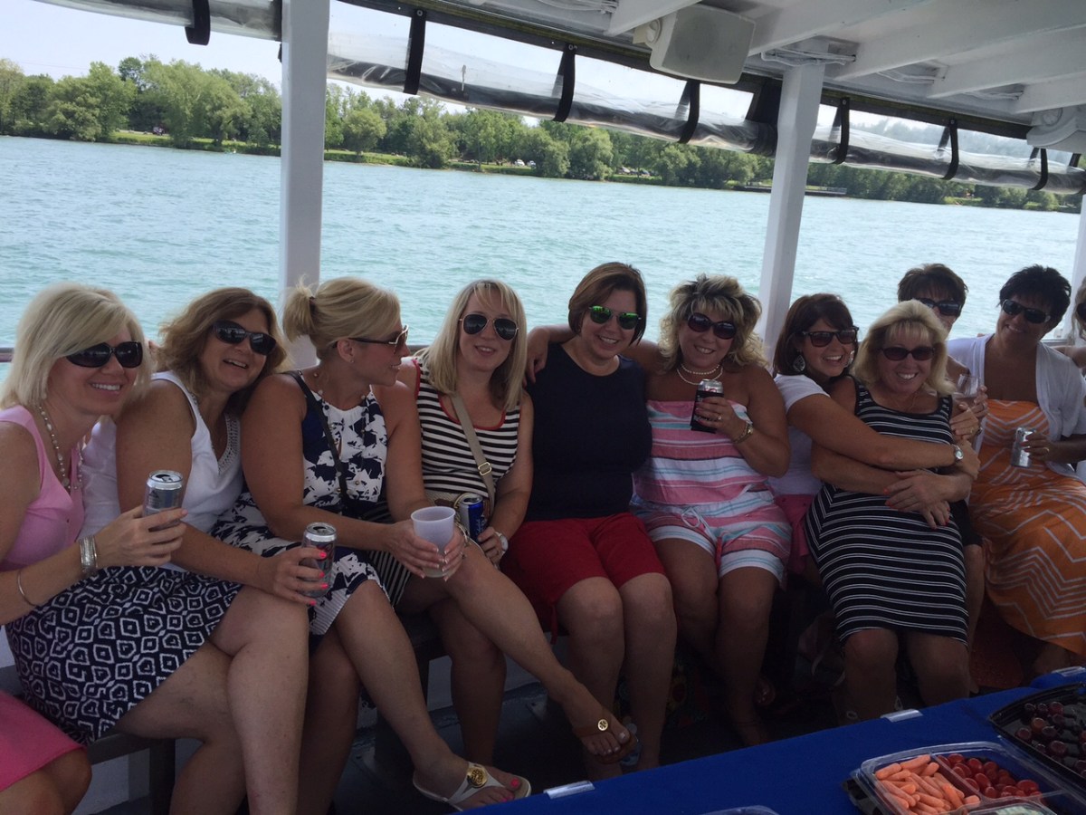 a group of people sitting in front of a body of water