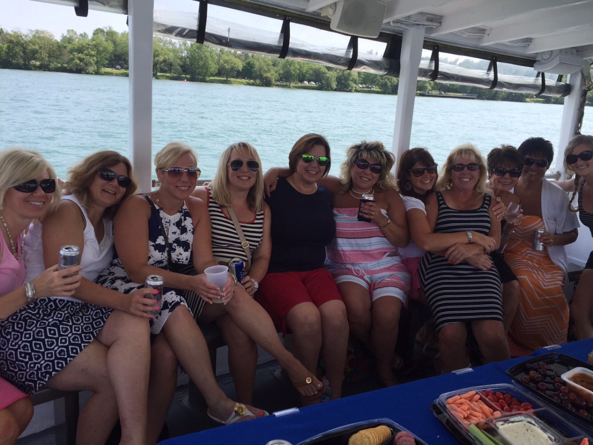 a group of people sitting in front of a body of water
