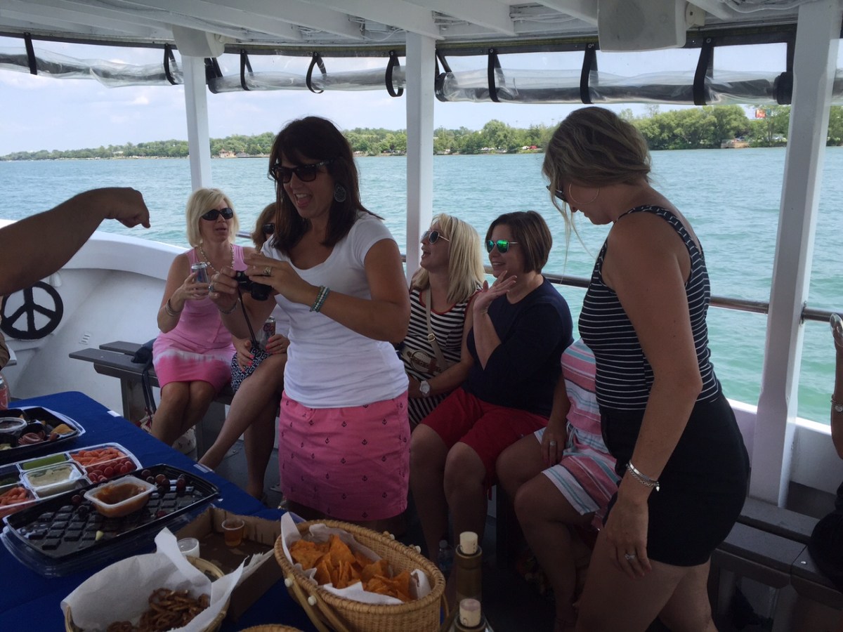 a woman sitting at a picnic table in front of a body of water