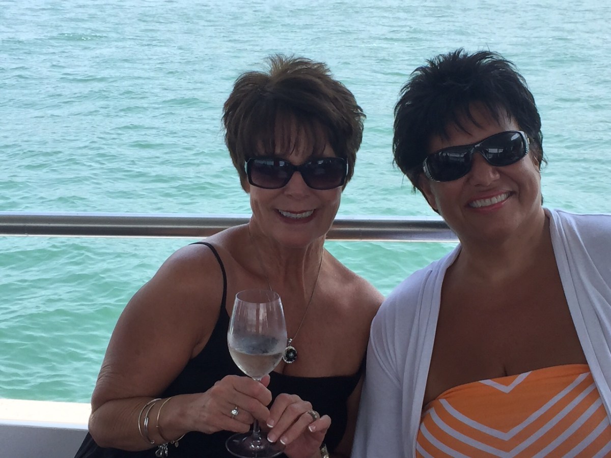 a couple of people are drinking from the water