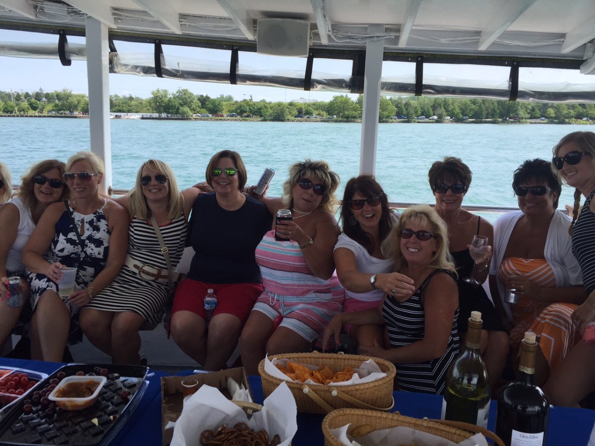 a group of people sitting in front of a body of water