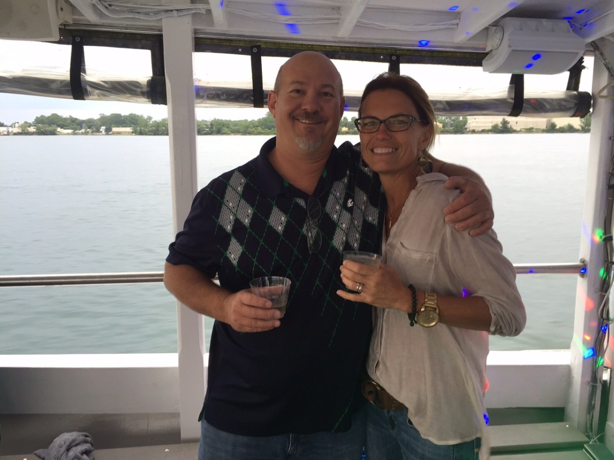 a man and a woman standing in front of a window