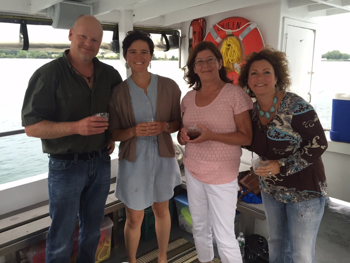 a man standing in front of a group of people posing for the camera