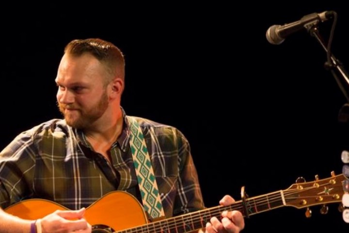 a man holding a guitar