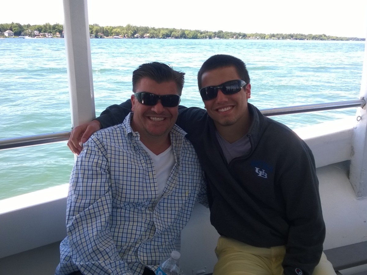 a man standing in front of a body of water