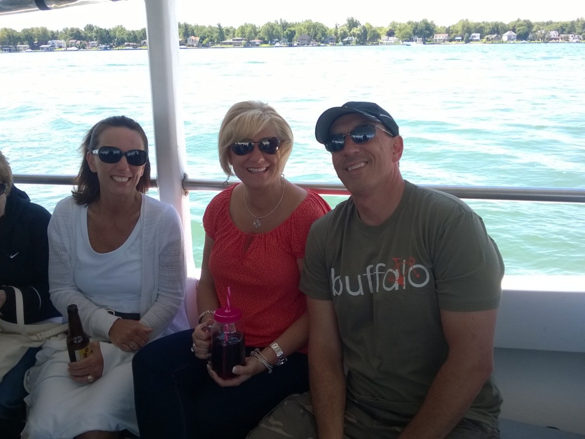 a couple of people that are sitting next to a body of water