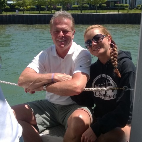 a man and woman sitting next to a body of water