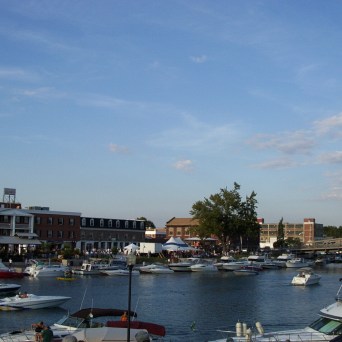 a small boat in a harbor next to a body of water