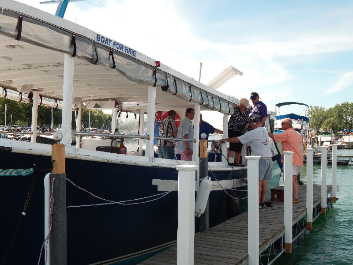 a group of people standing next to a body of water