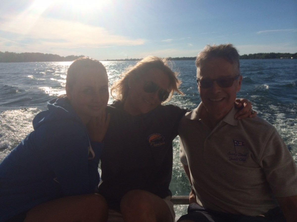 a couple of people that are standing in front of a body of water