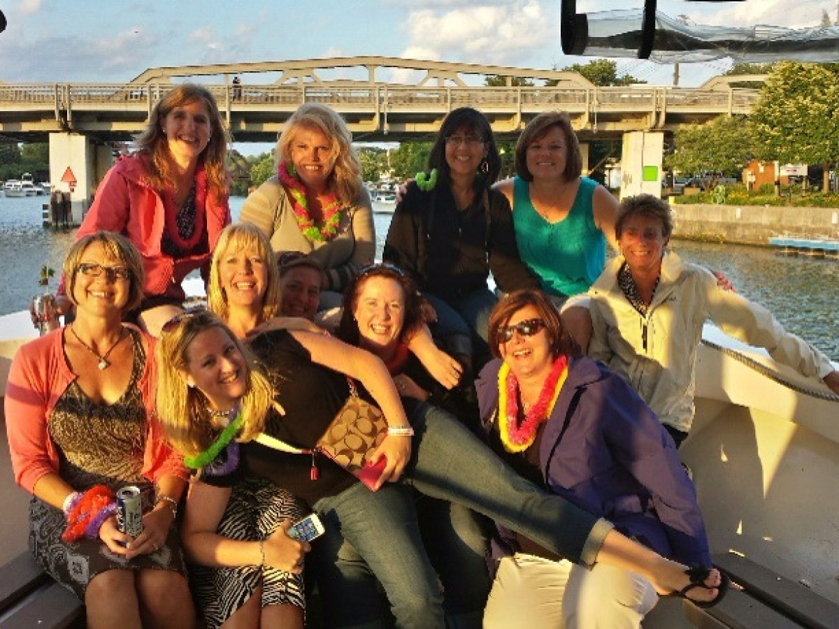 a group of people on a boat posing for the camera