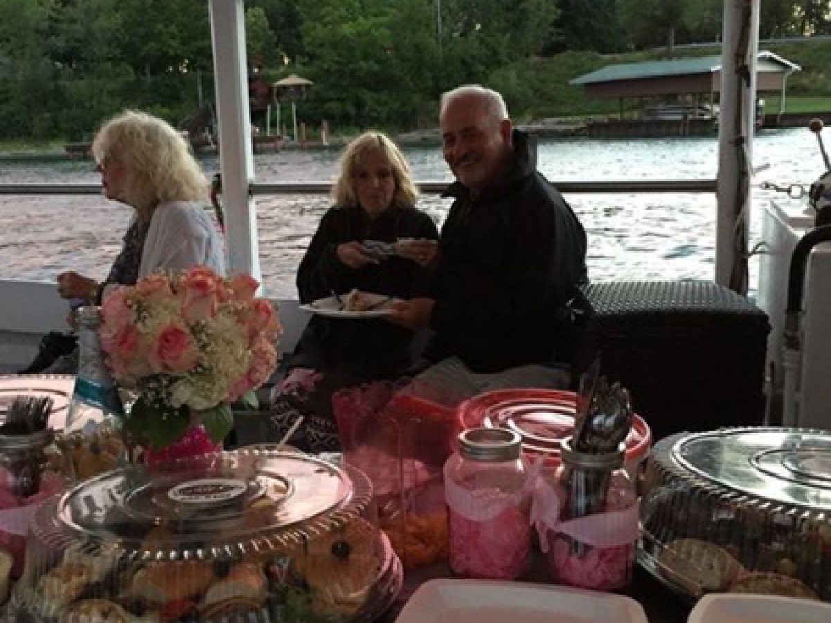 a group of people sitting at a table with food