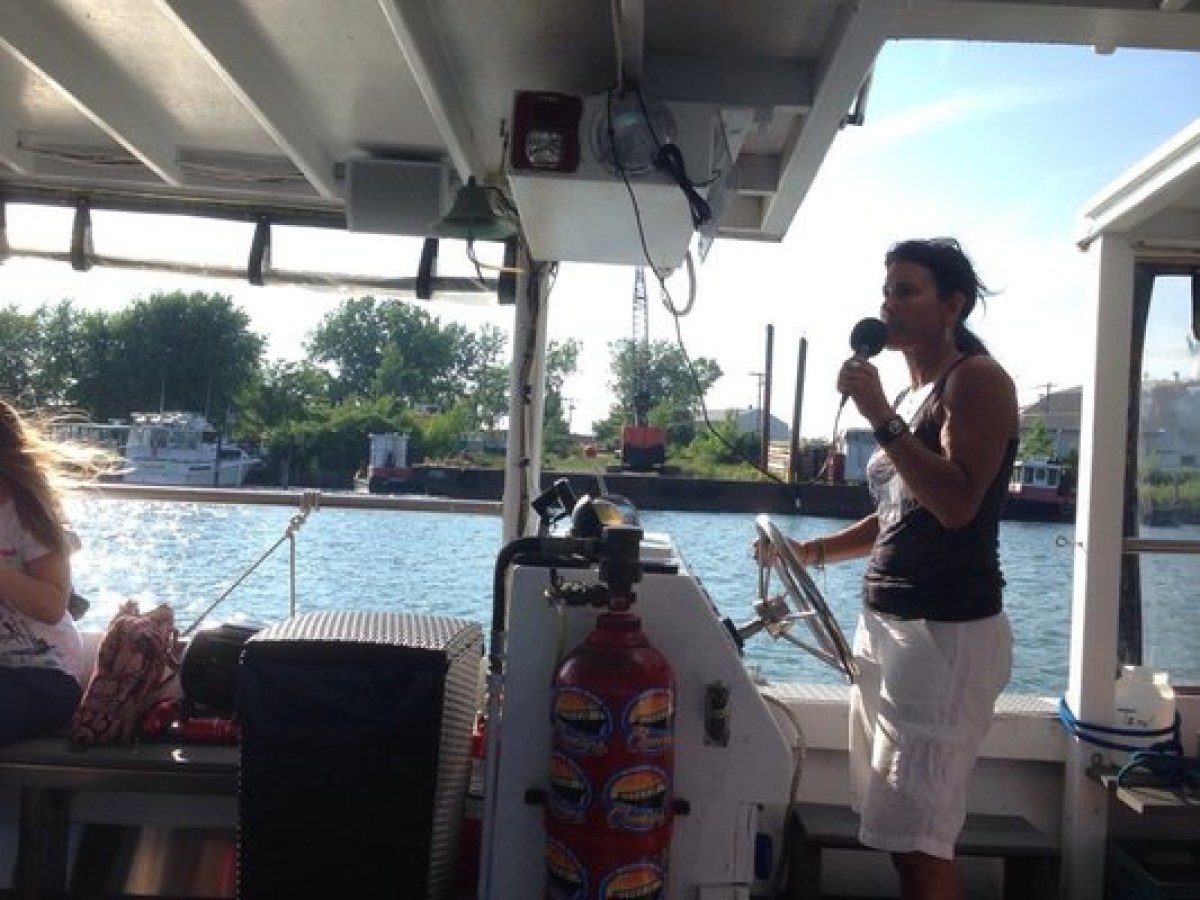 a man and a woman standing in front of a boat