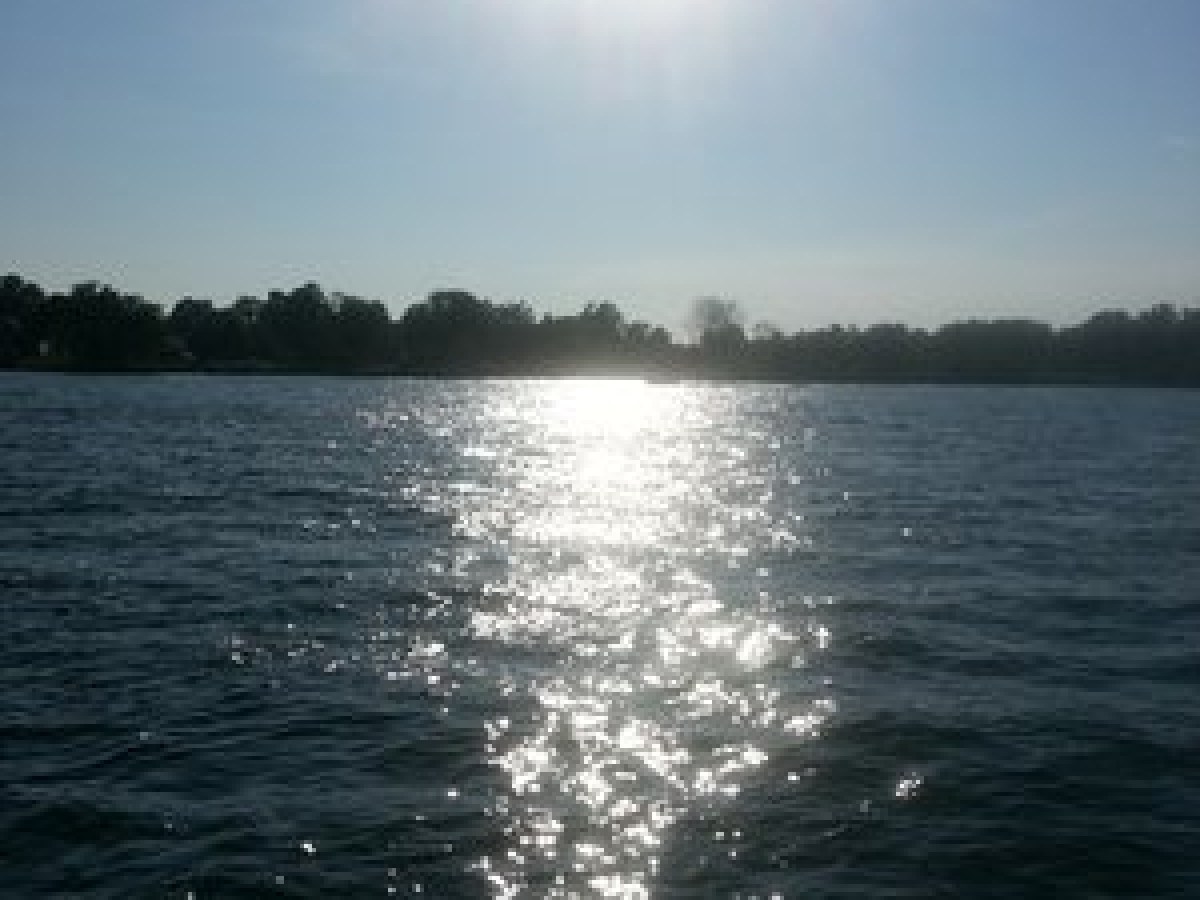 a man standing next to a body of water