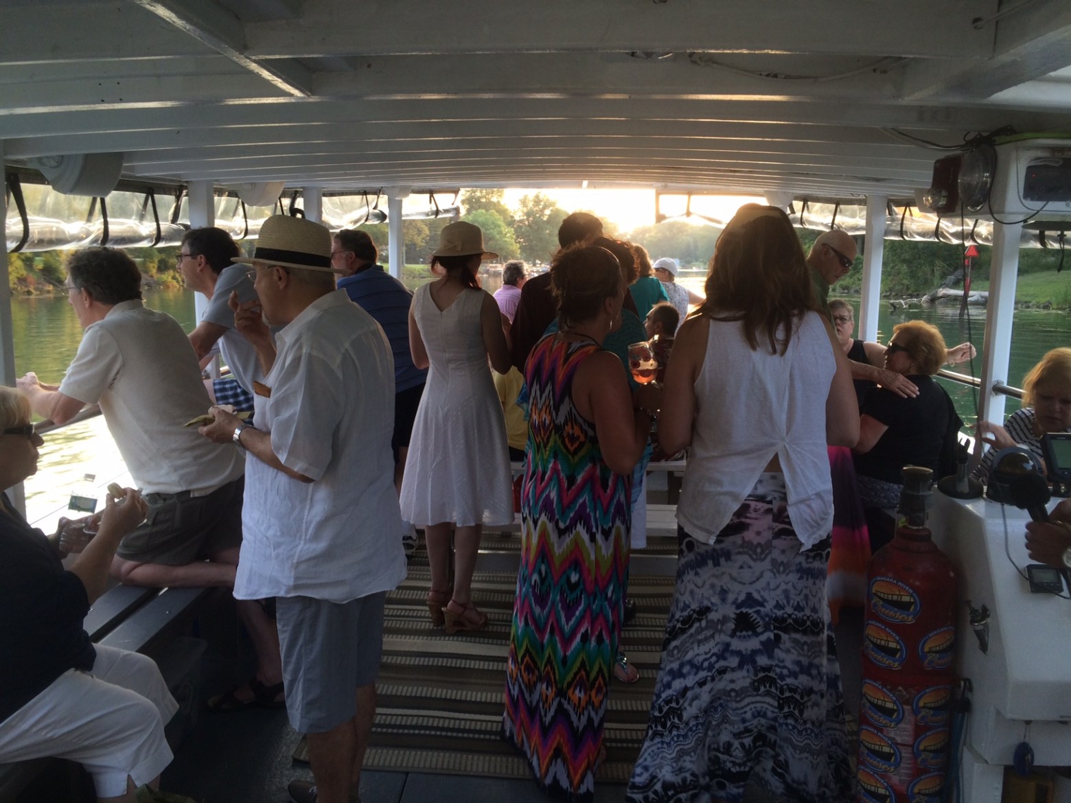 a group of people standing around a luggage carousel at an airport