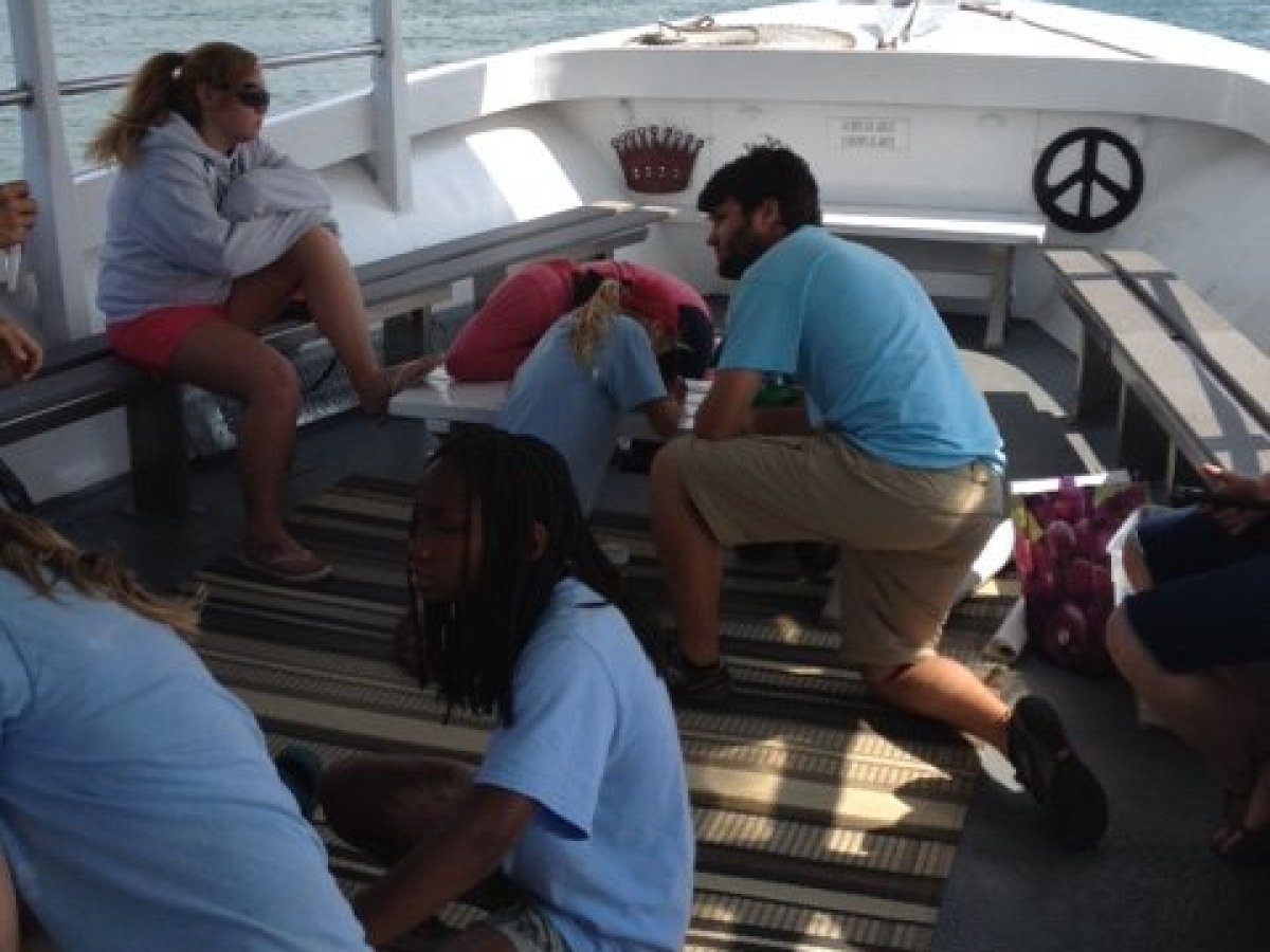 a group of people sitting at a dock