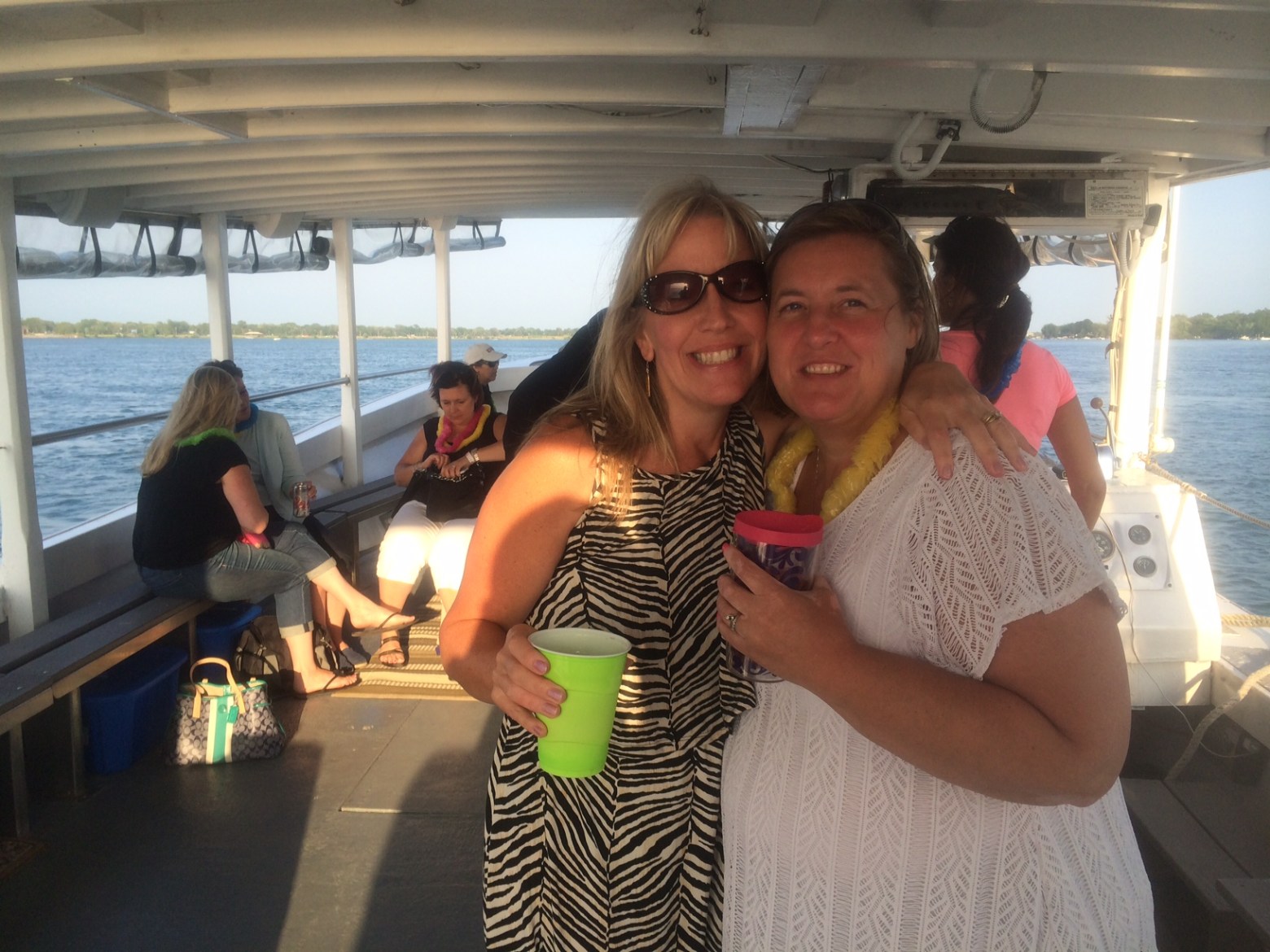 a woman standing in front of a group of people posing for the camera