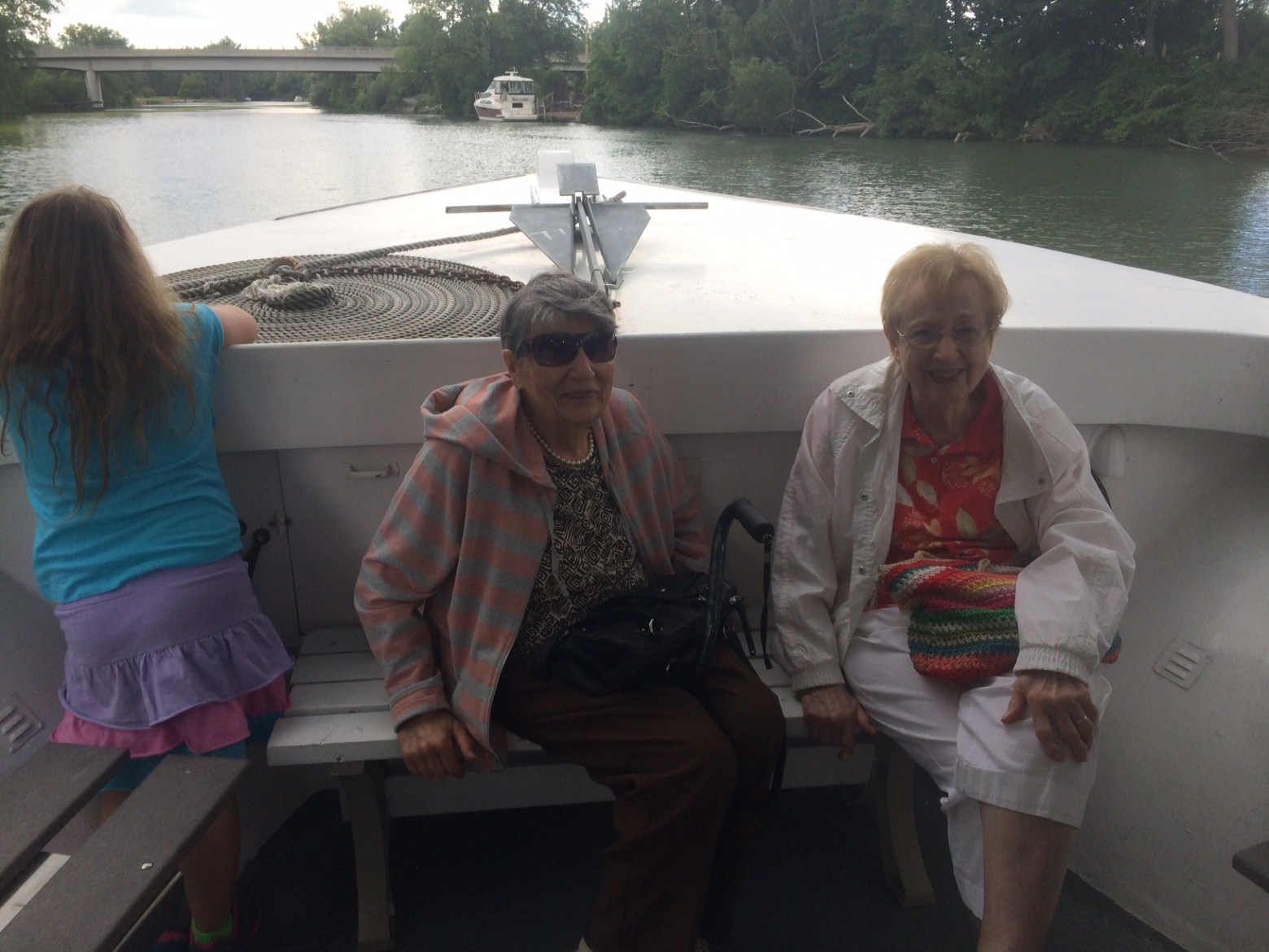 a group of people standing in front of a body of water