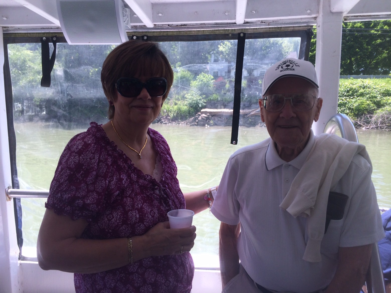 a man and a woman standing in front of a window