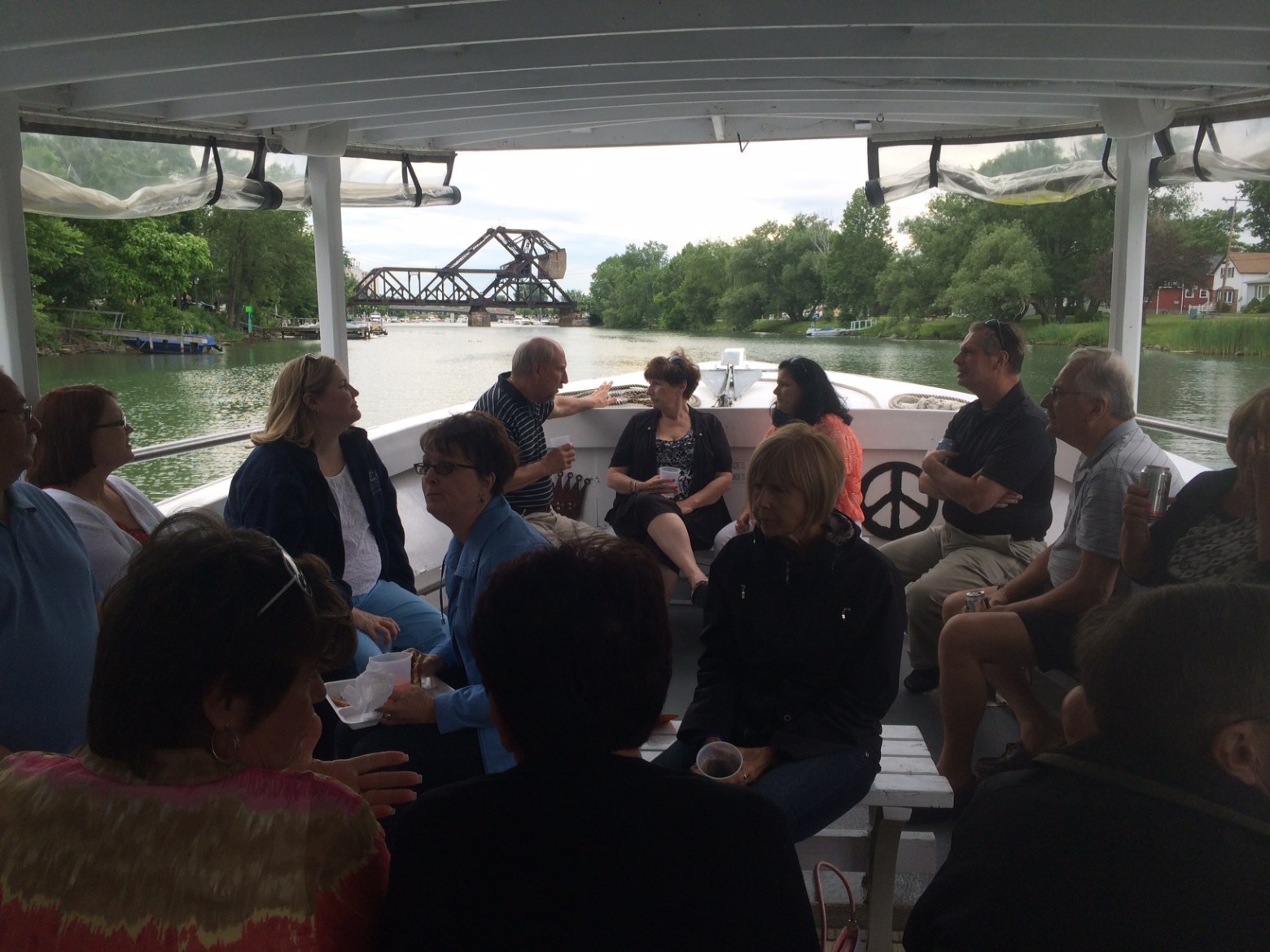 a group of people sitting at a table with a crowd watching