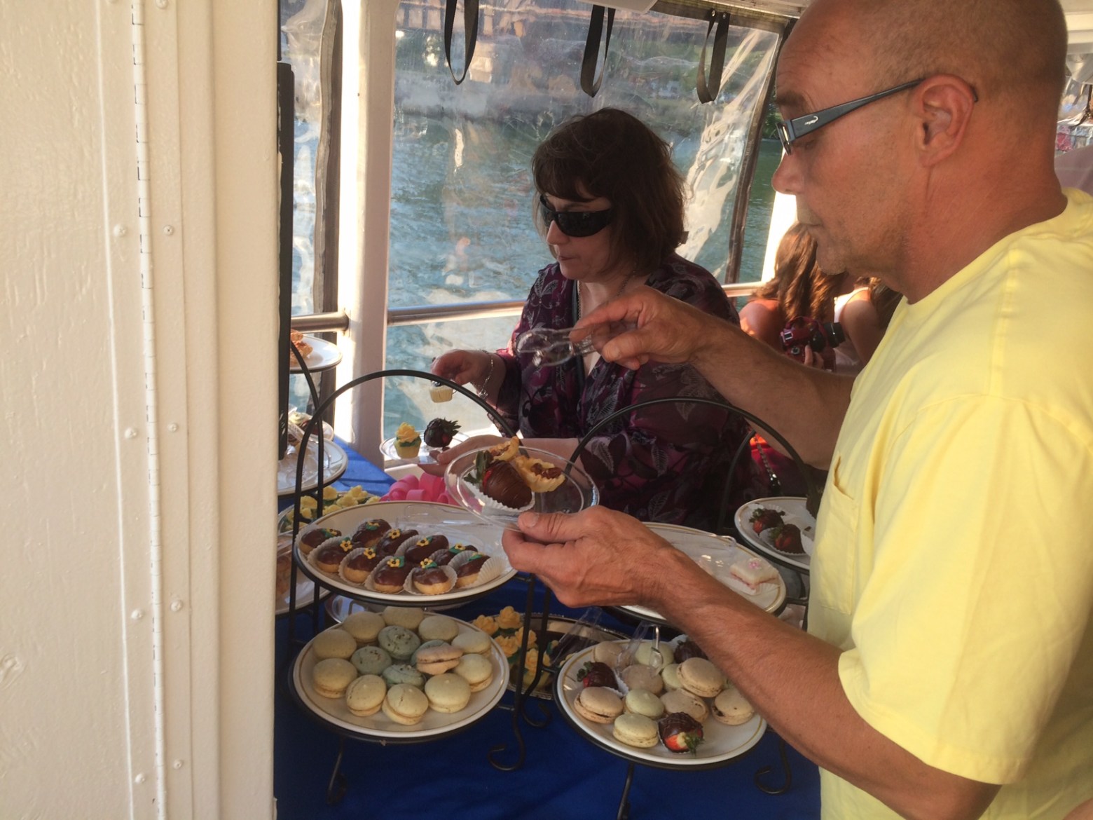 a man and woman cooking food on a table