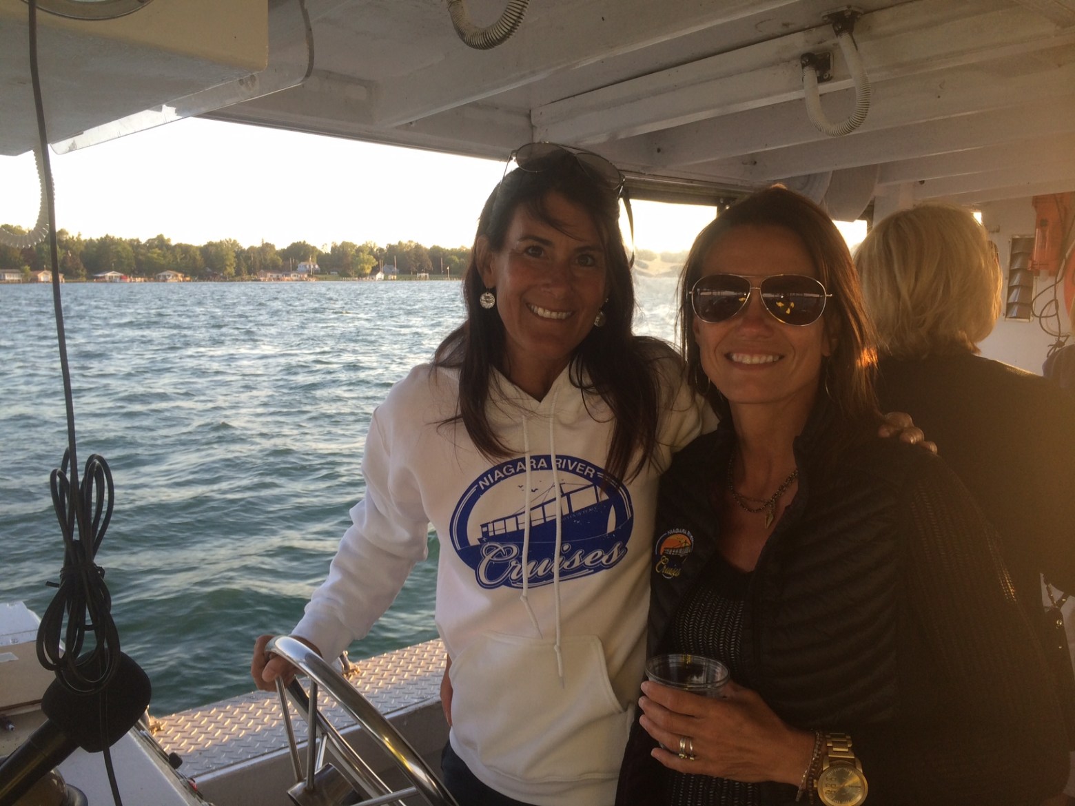 a man and a woman standing on a boat in the water