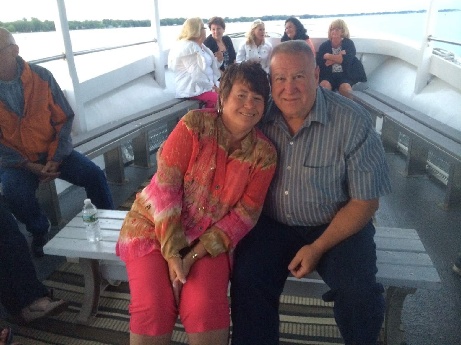 a group of people sitting and standing in front of a window