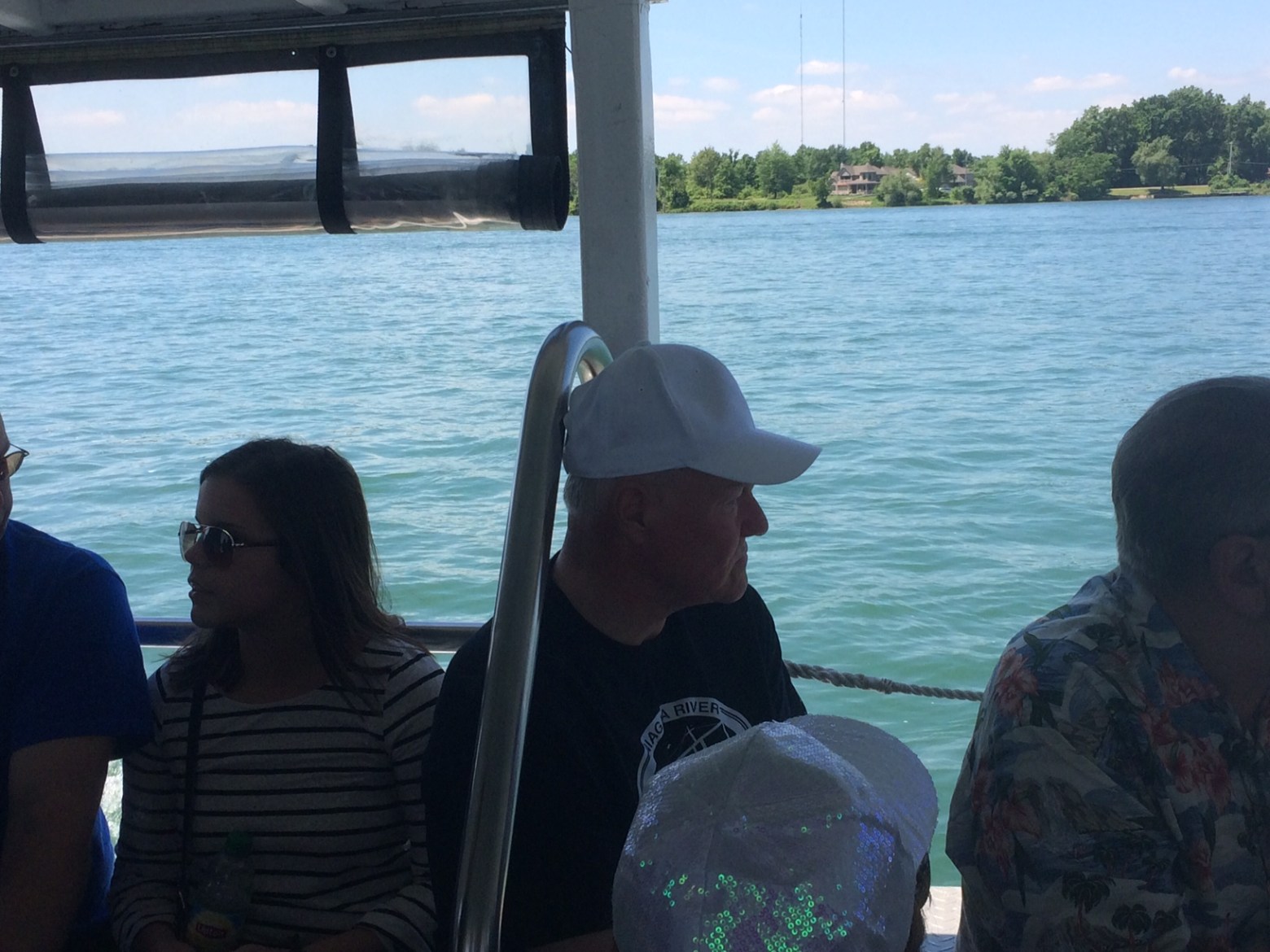 a couple of people that are sitting next to a body of water