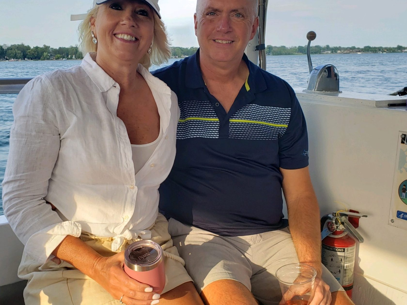 a couple of people that are sitting on a boat posing for the camera