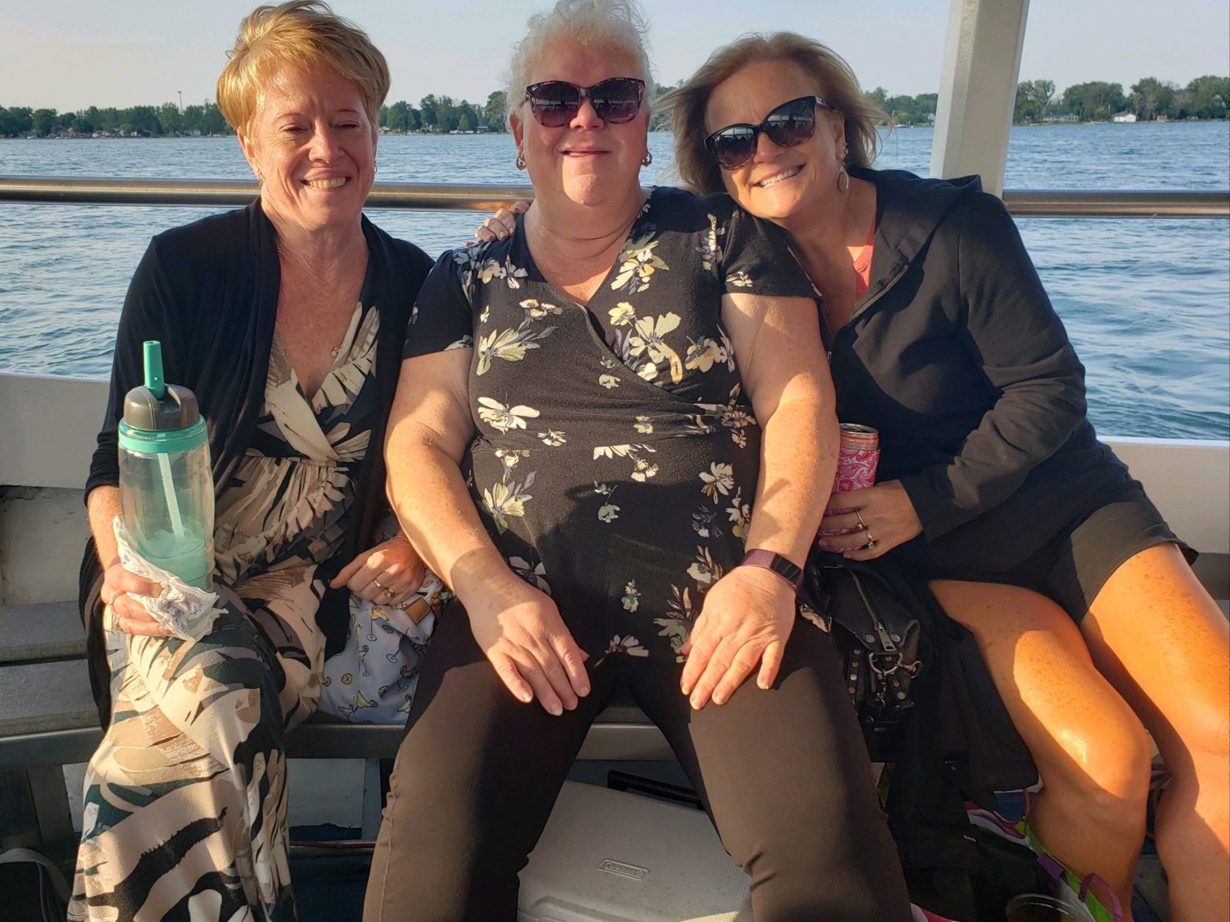 a couple of people that are sitting on a boat posing for the camera