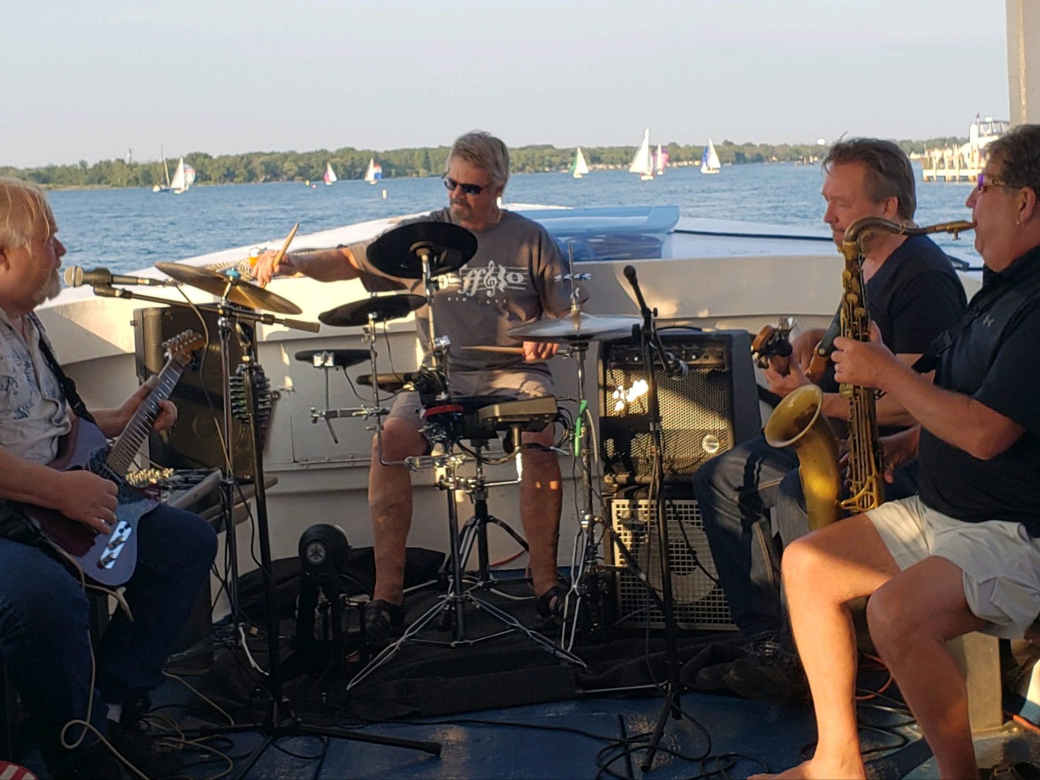 a group of people sitting on a boat in the water