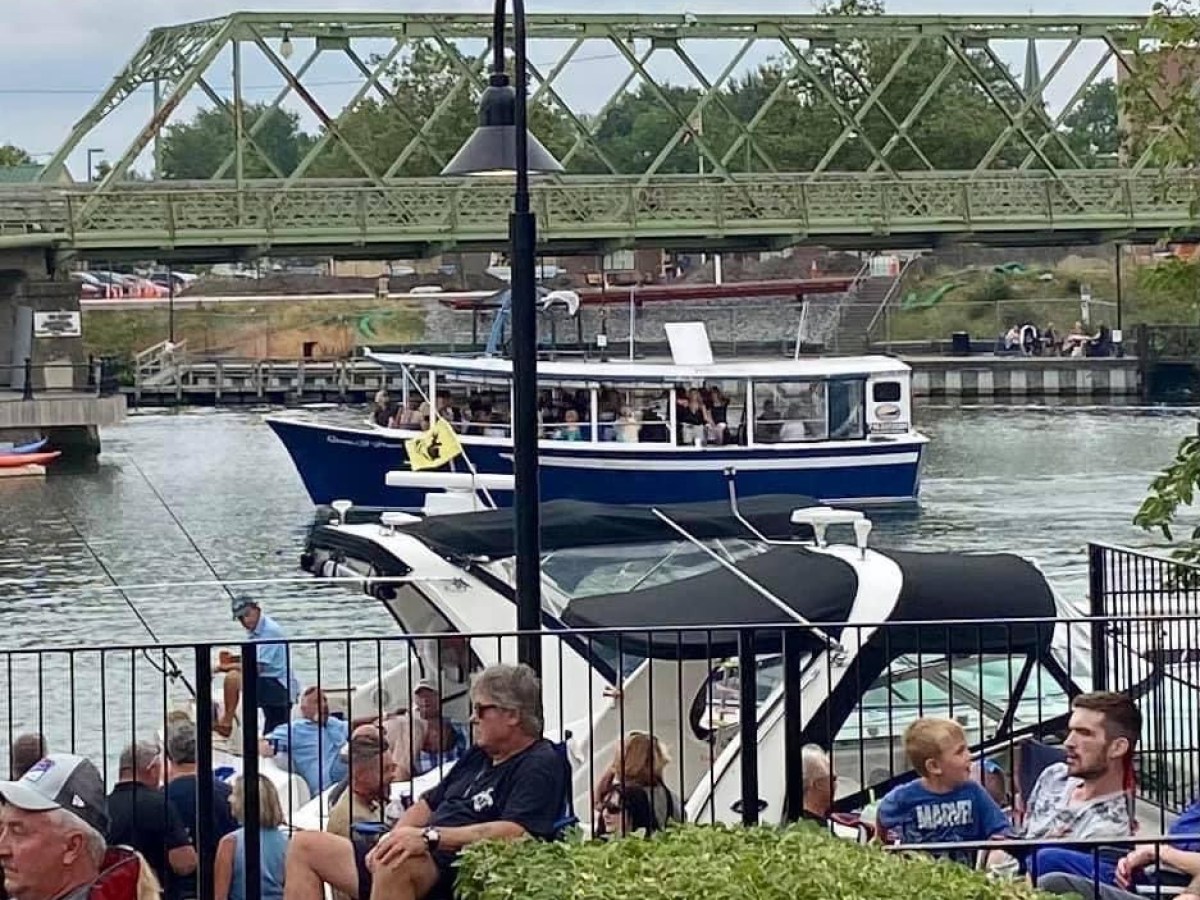 a group of people on a bridge over a body of water