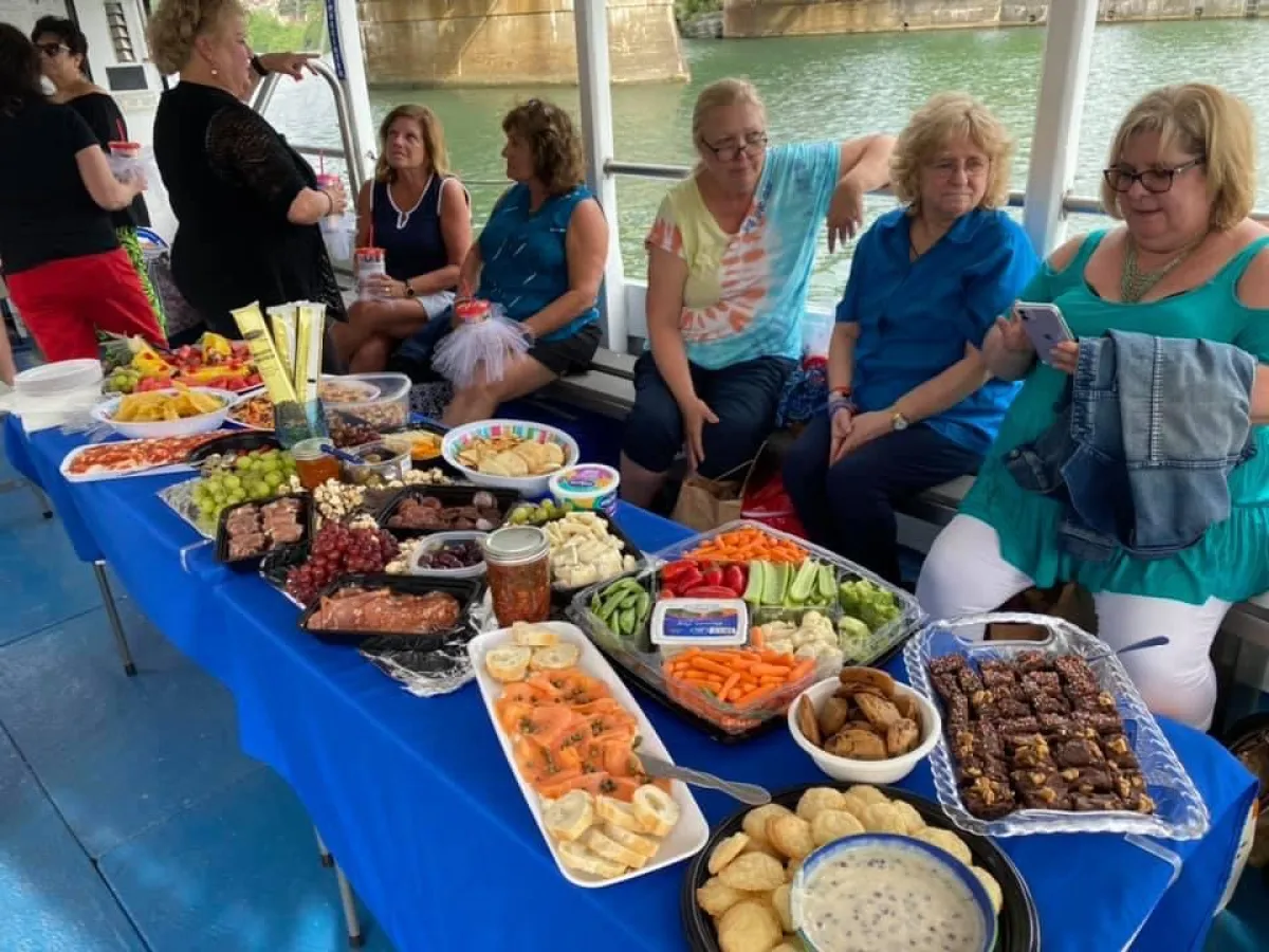 a group of people sitting at a table full of food