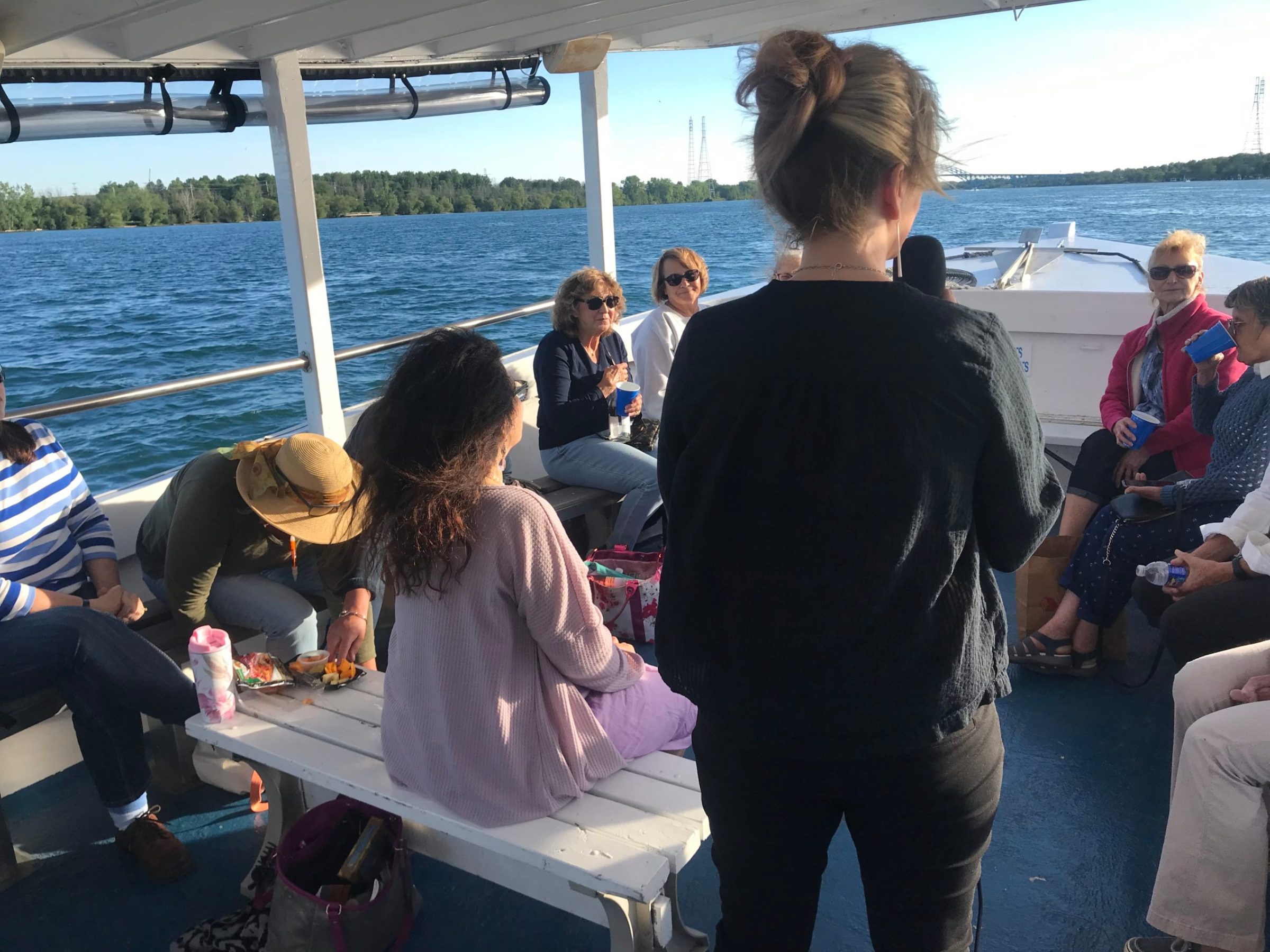 a group of people standing next to a body of water