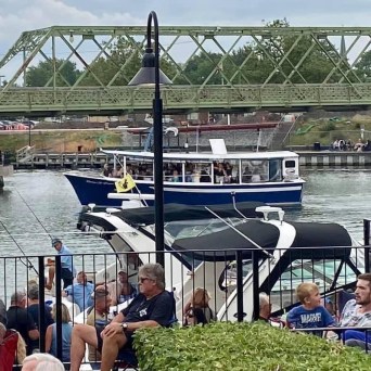 a group of people on a bridge over a body of water