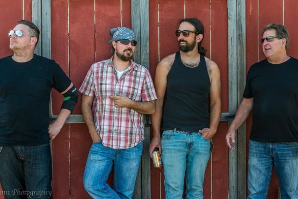 a man standing in front of a group of people posing for the camera